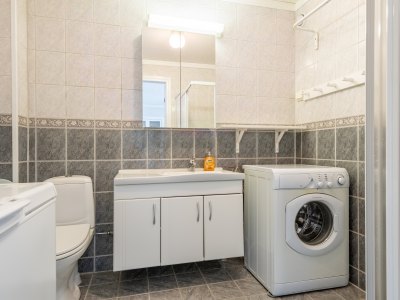 Bathroom with washing machine and sink.