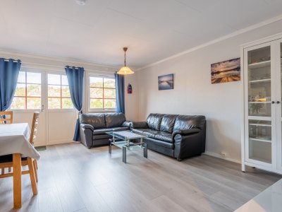 Living room with sofa and windows.