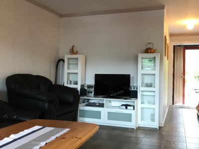 Apartment Type 1 living room with TV and sofa – Sotra Rorbusenter