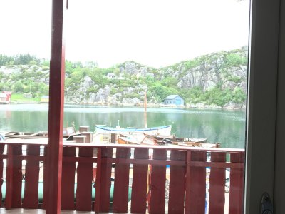 Balcony view of fjord and mountains.