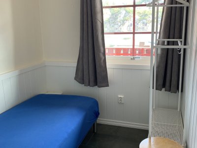Bedroom with single bed and blue bedding.