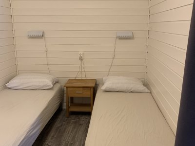 Bedroom with two twin beds and nightstand.