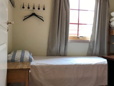 Bedroom with single bed, bunk bed, and window.