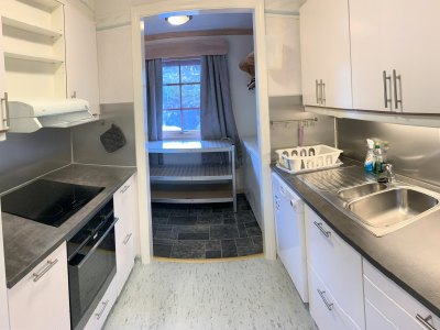 Kitchen with cabinets, oven, and sink.