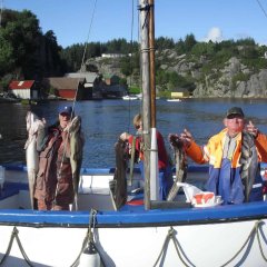 Group with ling and pollock catch at harbor.