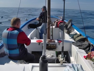 Guests fishing from boat during deep sea trip.