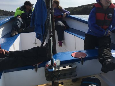 Guests relaxing in motorboat during deep sea fishing trip.