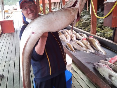 Fisherman holding large conger eel.