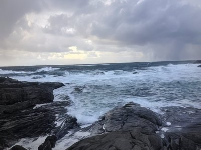 Coastal landscape with waves crashing on rocks in Sotra.
