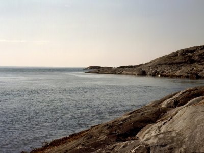 Rocky coastline with calm sea in Sotra.