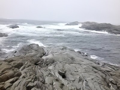 Rocky coastline with ocean waves in Sotra.