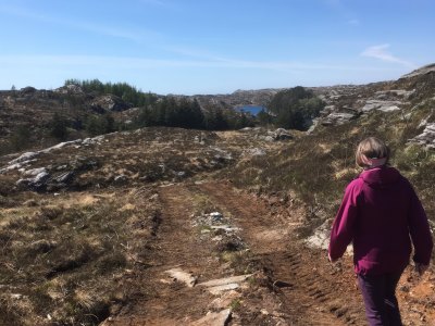 Hiker on coastal trail in Sotra, Norway