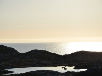 Sunset over a calm sea on the Sotra coast.