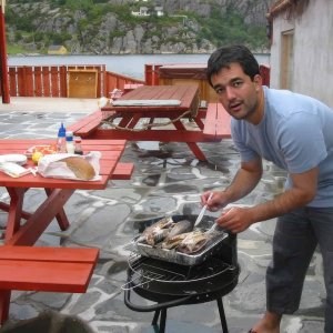 Guest grilling fresh fish outdoors.