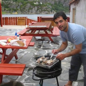 Guest grilling fresh fish outdoors.