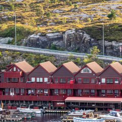 Sotra Rorbusenter waterfront apartments with boats docked.