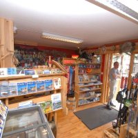 Fishing gear shop with shelves and equipment.