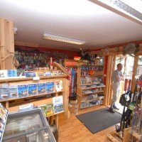 Fishing gear shop with shelves and equipment.