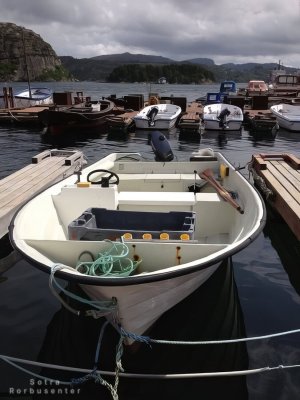 Rental motorboat for fishing at harbor.