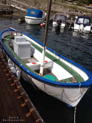 Traditional open-deck motorboat for fishing.