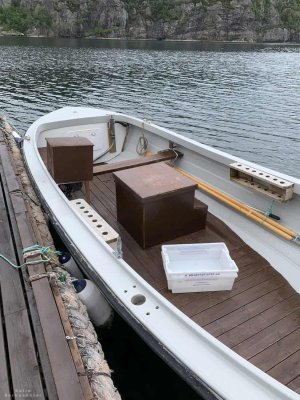 Wooden motorboat rental with open deck.