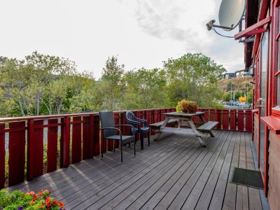 Balcony with seating area and flowers.
