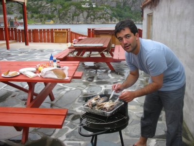 Guest grilling fresh fish outdoors.