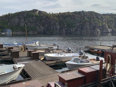 Harbor with boats docked by the fjord.