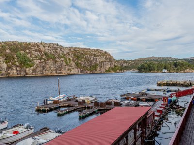 Harbor with boats and fjord view.