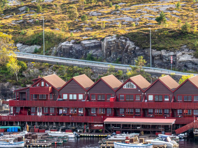 Sotra Rorbusenter waterfront apartments with boats docked.
