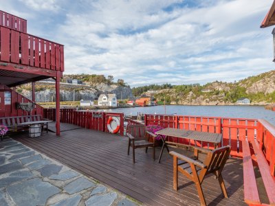 Terrace with seating and fjord view.