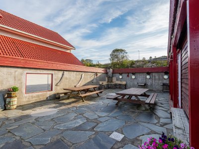 Terrace with stone patio, tables, and benches.