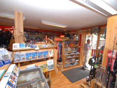 Fishing gear shop with shelves and equipment.