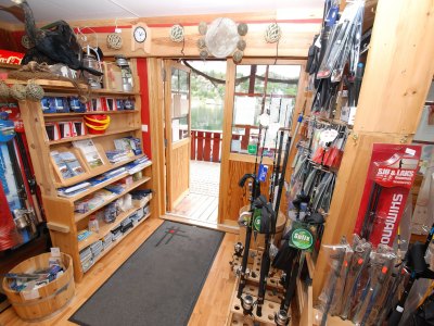 Fishing gear shop with rods, reels, and equipment.
