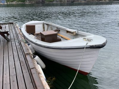 Traditional wooden motorboat for fishing rental.
