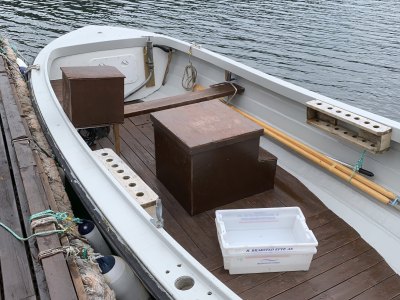 Wooden motorboat rental with open deck.